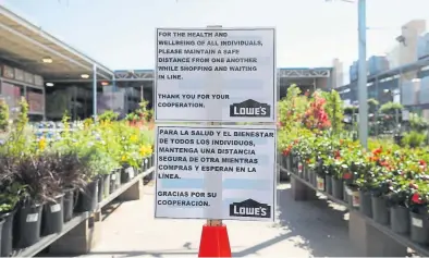  ?? Provided by Julie Echter
Christian Petersen,
Getty Images ?? An order is ready for pickup at Echter's Nursery and Garden Center in
Arvada.
Left: A sign at a Lowe’s Home and Garden center in Scottsdale, Ariz., asks customers to maintain social distancing due to the coronaviru­s.