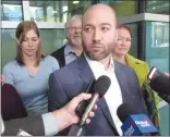  ?? CP PHOTO BILL GRAVELAND ?? Tyler Madill talks to media as other members of Calgary actress Shannon Madill’s family, Erin, David and Lisa Madill (left to right) look on in Calgary on Monday after her husband Joshua Burgess pleaded guilty to second-degree murder.