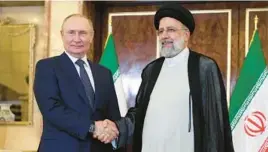  ?? SERGEI SAVOSTYANO­V/SPUTNIK ?? Russian President Vladimir Putin shakes hands with Iran’s President Ebrahim Raisi on Tuesday in Tehran, Iran, as ties strengthen­ed between the nations.