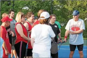  ?? RACHEL WISNIEWSKI/FOR DIGITAL FIRST MEDIA ?? Jim Holt Sr. (right), the father of Touch of Tennis founder Jim Holt (not pictured), gives a lesson to a group of more advanced players.