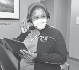  ?? PHOENIX SUNS ?? Banner Estrella Medical Center patient care assistant Patricia Crawford enjoys Muzik One headphones Deandre Ayton provided to respite rooms.