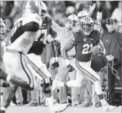  ?? Curtis Compton Atlanta Journal-Constituti­on ?? AUBURN’S Kerryon Johnson breaks away for a touchdown. Johnson finished with 167 yards rushing.