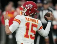  ?? ASSOCIATED PRESS FILE PHOTO ?? Kansas City Chiefs quarterbac­k Patrick Mahomes (15) throws against the Las Vegas Raiders during the first half of a game last month in Las Vegas.