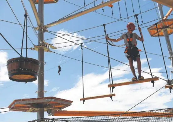  ?? Seth McConnell, The Denver Post ?? Logan Ballard traverses an obstacle at Castle Rock Zip Line Tours.