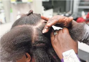  ?? GREG SWIERCZ/USA TODAY NETWORK ?? Eighteen states have enacted the CROWN Act, a law prohibitin­g discrimina­tion based on hair texture and hairstyles, but many Black women in the U.S. face discipline or pushback for how they wear their hair.