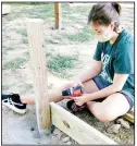  ??  ?? Using a drill, one Scout assembles the base of one project.
(Courtesy Photo)