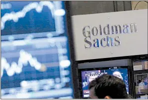  ?? AP file photo ?? A screen at a trading post on the floor of the New York Stock Exchange is juxtaposed with the Goldman Sachs booth. Goldman Sachs will start offering home-improvemen­t loans this month.