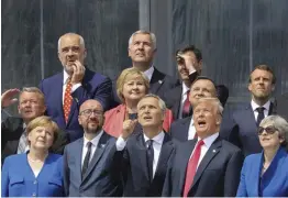  ?? — AP ?? US President Donald Trump joins European leaders, including German Chancellor Angela Merkel, Nato secretary- general Jens Stoltenber­g, Britain’s Prime Minister Theresa May, French President Emmanuel Macron, for a “family picture” ahead of the opening ceremony of the Nato summit in Brussels on Wednesday.