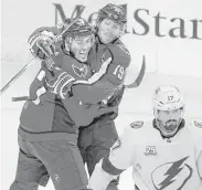  ?? Alex Brandon / Associated Press ?? The Caps’ T.J. Oshie, left, celebrates his first goal with Nicklas Backstrom to the chagrin of Alex Killorn.