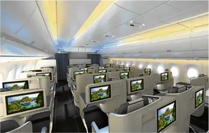  ??  ?? Business class cabin has airy space (no cabin storage bin in the center) and mood lighting.