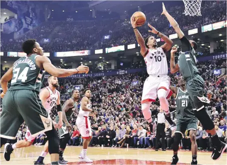  ?? FRANK GUNN/THE CANADIAN PRESS ?? Raptors guard DeMar DeRozan shoots over Milwaukee Bucks forward John Henson in Toronto Monday.