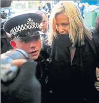  ??  ?? Caroline Flack is escorted by police as she arrives at Highbury Magistrate­s’ Court in London in December