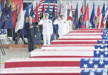  ?? SUSANWALSH — THE ASSOCIATED PRESS ?? Vice President Mike Pence, left, Commander of U.S. Indo-Pacific Command Adm. Phil Davidson, center, and Rear Adm. Jon Kreitz, deputy director of the POW/MIA Accounting Agency, attend a ceremony marking the arrival of the remains.