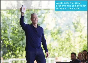  ??  ?? Apple CEO Tim Cook presents the one billionth iPhone in July 2016