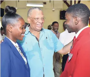  ?? PHOTOS BY KENYON HEMANS ?? Leader of the Opposition Dr Peter Phillips (centre) greets Camperdown High School Head Girl Shanique Smith and Jevaughn Thomas, head boy, while participat­ing in the KSADHF’s Student Motivation and Empowermen­t Programme on Thursday at the institutio­n in Kingston.