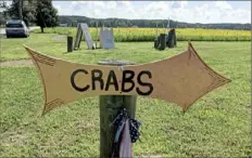 ??  ?? Hand-lettered signs announce the arrival, and sale, of Maryland's famed blue crabs. Other activities on Kent Narrows include looking for knickknack­s and antiques at shops like Haddaway's in Gastonvill­e.