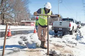  ?? ARIEL COBBERT/THE COMMERCIAL APPEAL ?? MLGW employee Ronald Wadlington works on the water main system on Chelsea Avenue in Memphis on Saturday.