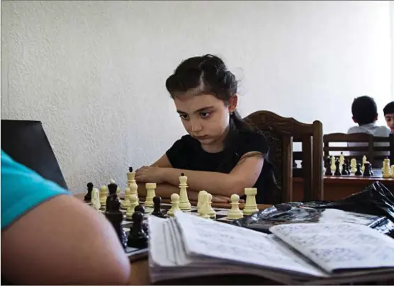  ?? FOTO: GINA GRIEG RIISNAES ?? Lilja (8) prøver å slå 12 år gamle Asjot på sjakkskole­n ved Skole nr. 49 i Jerevan i Armenia.