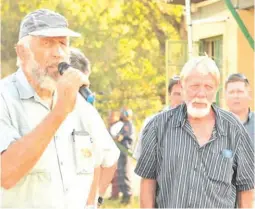  ?? ?? Jaap Breedt and his cousin, Faan Botha, at the flower vigil following the murder of Faan’s wife Annemarie and his stepson, Ruan Brits.