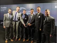  ?? U.S. Army ?? Robert Norwood (second from right) receives an award for the Cyber Policy Team.