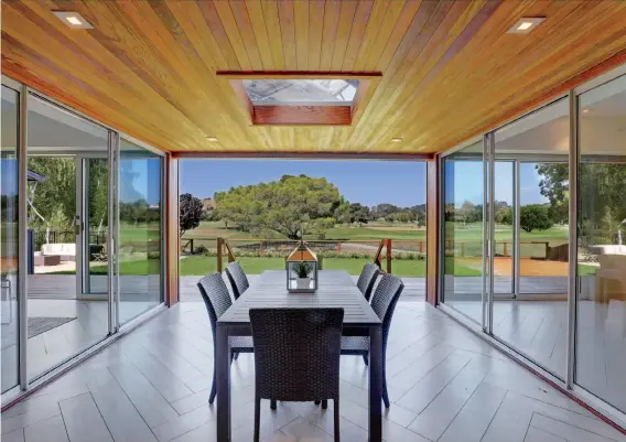  ??  ?? The wood-paneled veranda is accessed on three sides and includes a skylight. The freshly completed San Rafael five-bedroom home rests on a third of an acre.