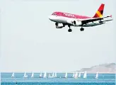  ?? ( AFP) ?? In this file photo taken on Aug 19, 2015 an Avianca airliner prepares to land in the Santos Dumont airport (not framed) as sailing boats compete in the Internatio­nal Sailing Regatta in the Guanabara Bay in Rio de Janeiro, Brazil. Avianca Brazil, overwhelme­d by debts, recoursed to the bankruptcy law on Dec 11,2018.