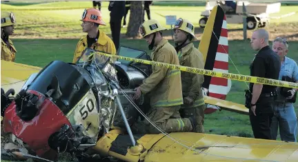  ??  JONATHAN ALCORN/AFP/GETTY IMAGES ?? Firefighte­rs inspect the cockpit of a plane that crashed on a golf course in Venice, California, piloted by actor Harrison Ford on Thursday. The 72-year-old Indiana Jones and Star Wars actor suffered multiple gashes to his head after the crash of the...