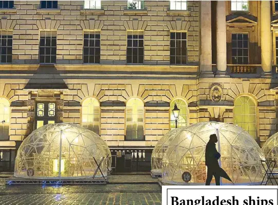  ?? REUTERS ?? A man walks past Winter Domes – outdoor dining pods erected in the courtyard of Somerset House to enable restaurant eating amid the coronaviru­s outbreak in the United Kingdom on Thursday.