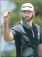  ?? Mike Ehrmann Getty Images ?? DUSTIN JOHNSON celebrates a birdie, one of four he made Friday.