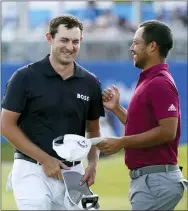  ?? GERALD HERBERT — THE ASSOCIATED PRESS ?? Patrick Cantlay greets teammate Xander Schauffele, right, on the 18th green after completing their third round of the PGA Zurich Classic golf tournament, Saturday, April 23, 2022, at TPC Louisiana in Avondale, La.