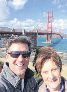  ??  ?? Virginia Loeffelhol­z her son, Chris, pose in front of the Golden Gate Bridge in San Francisco. Chris has run in the San Francisco Marathon. Virginia will join him in her first Redbud race on Sunday.