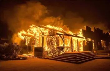  ?? Phil Pacheco/Bloomberg ?? A structure burns at Soda Rock Vineyards on Oct. 27, 2019, in Healdsburg, Calif.