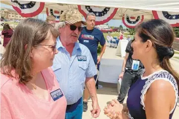  ?? TOM BEAUMONT/AP ?? Nikki Haley, right, talks with Bob and Kathy de Koning in Sioux County, Iowa. Haley, who could seek the Republican presidenti­al nomination in 2024, was the ambassador to the United Nations under former President Donald Trump.