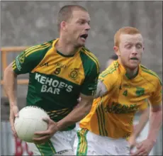  ??  ?? Conor Kinsella (HWH-Bunclody) evades Peter Goldsmith.