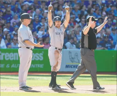  ?? Fred Thornhill / Associated Press ?? Brett Gardner gestures to the Yankee dugout after hitting a triple in the third inning against the Blue Jays on Saturday.