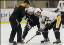  ?? KEITH SRAKOCIC — THE ASSOCIATED PRESS ?? Pittsburgh’s Sidney Crosby, center, practices face-offs with Carter Rowney, right, Friday at the team practice facility in Butler County, Pa.