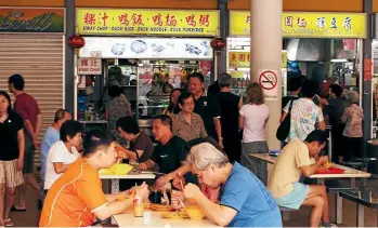  ??  ?? A packet placed on the table is a signal that it is yours – known locally as to ‘‘chope’’ – leaving you free to wait in line to collect your food at leisure from your chosen vendor.