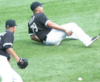  ??  ?? Sox first baseman Jose Abreu grimaces after injuring himself while going for a grounder in the fifth inning Wednesday. | NAM Y. HUH/ AP