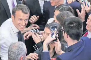  ?? AFP ?? French President Emmanuel Macron is greeted by students at Georges Washington University on Wednesday in Washington, DC.