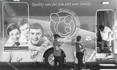  ?? JAE C. HONG/AP ?? Two women wait their turn outside a mobile clinic before getting the Moderna COVID-19 vaccine Thursday in Orange, California.