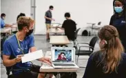  ?? Brett Coomer / Staff file photo ?? Student Ethan Kelly, left, attends a lab in a temporary building in September on the Rice University campus.