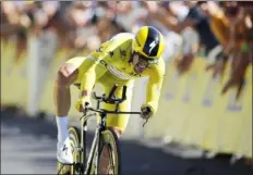  ?? CHRISTOPHE ENA - THE ASSOCIATED PRESS ?? France’s Julian Alaphilipp­e wearing the overall leader’s yellow jersey crosses the finish line to win the 13th stage of the Tour de France cycling race, an individual time trial over 16.9miles with start and finish in Pau, France on July 19.