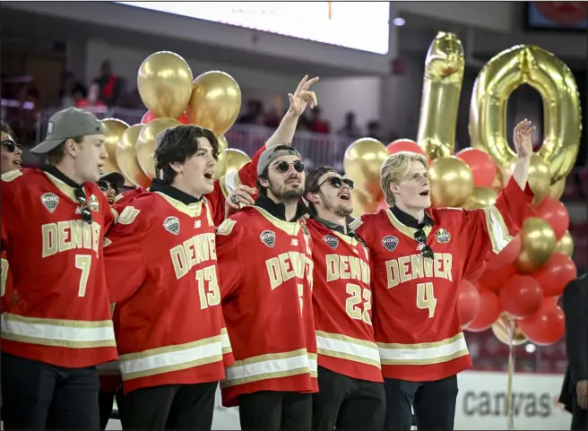  ?? AARON ONTIVEROZ — THE DENVER POST ?? Denver Pioneers hockey players Aidan Thompson ( 7), Massimo Rizzo ( 13), Mckade Webster ( 6), Connor Caponi ( 22) and Jack Devine ( 4) sing John Denver’s “Rocky Mountain High” during a celebratio­n of the Pioneers’ record- setting 10th national championsh­ip at Magness Arena on the DU campus on Monday.