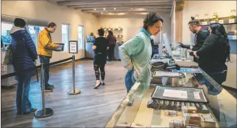  ?? NATHAN BURTON/Taos News ?? Customers wait in lines throughout the day Friday (April 1) at Southwest Cannabis and Taos Cannabis Coop on New Mexico’s opening day of recreation­al cannabis sales.