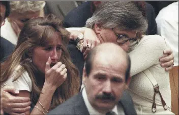  ?? MYUNG J. CHUN — LOS ANGELES DAILY NEWS FILE ?? Fred Goldman, father of Ron Goldman, hugs his wife, Patti, as his daughter, Kim, left, reacts during the reading of the not-guilty verdicts in O.J. Simpson’s double-murder trial on Oct. 3, 1995, in Los Angeles.