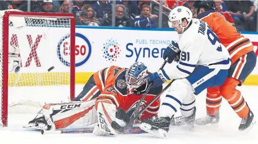  ?? CURTIS COMEAU GETTY IMAGES ?? Leaf John Tavares chips his 38th goal, tying a career high, past Oilers goalie Anthony Stolarz in the second period. Stolarz was a surprise starter in Edmonton.