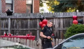  ?? Emily Matthews/Post-Gazette ?? Police officers respond to a shooting in the 1500 block of Sedgwick Street, where three people were hit by bullets during a party on Saturday evening in Manchester.