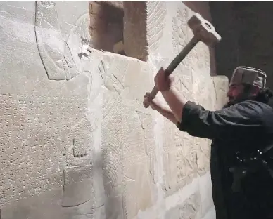  ?? THE ASSOCIATED PRESS ?? In this image from an ISIL-affiliated group’s social media account, a man smashes a relief in the ancient Assyrian city of Nimrud, near Mosul, Iraq. The Assyrians, an ancient non-Muslim minority, have been targeted by ISIL extremists.