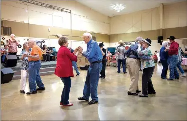  ?? NWA Democrat-Gazette/SPENCER TIREY ?? Sue Lambert and Jim Gideon (second from left) dance Thursday along with William and Donna Green (second from right) and others during a dance and 100th birthday party for Rozella Scott at the Springdale Senior Center. The City Council will vote Tuesday on whether to take on center as a city department.