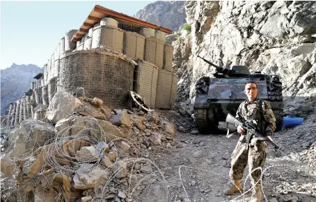  ?? File/Reuters ?? An Afghan soldier stands guard at a checkpost at Mahipar on Jalalabad-Kabul highway amid growing concerns about Taliban’s gains in recent weeks.